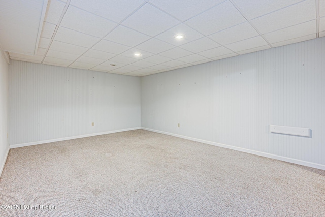 carpeted spare room with a drop ceiling, recessed lighting, and baseboards