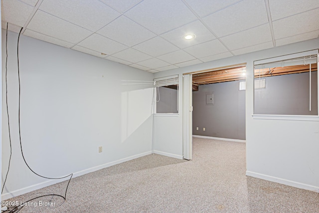 finished basement featuring recessed lighting, a paneled ceiling, baseboards, and carpet