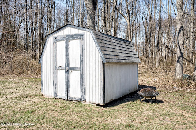 view of shed with an outdoor fire pit