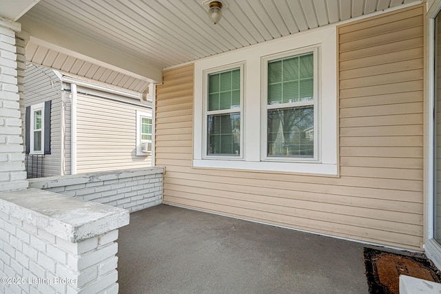 view of patio featuring cooling unit and covered porch