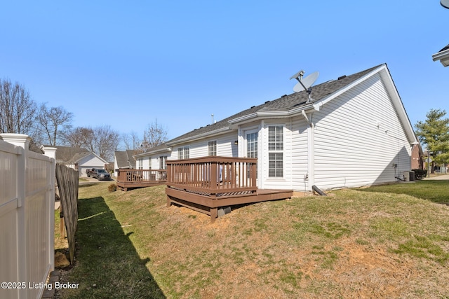 back of property featuring a yard, fence, cooling unit, and a wooden deck