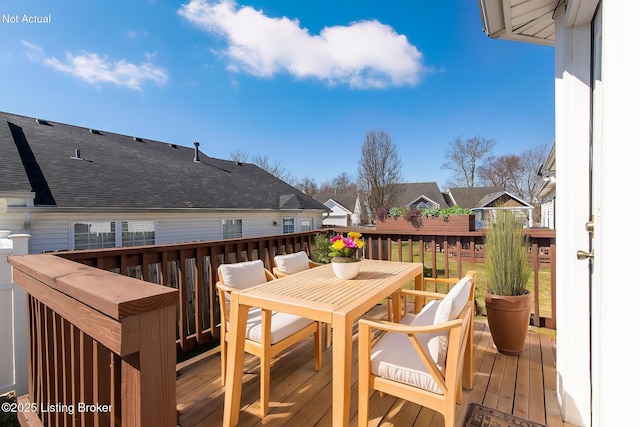 wooden terrace featuring outdoor dining area