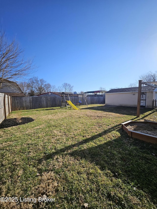 view of yard featuring a fenced backyard and a playground