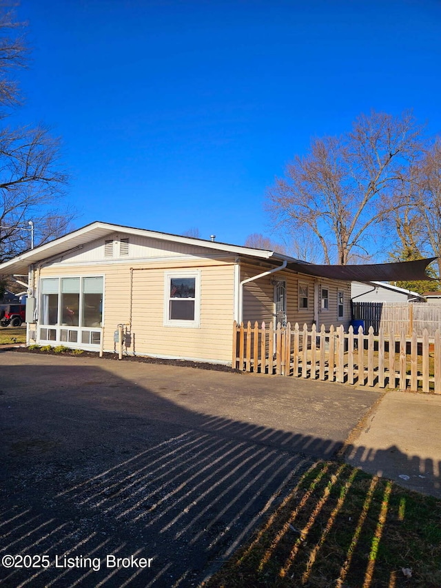 back of property featuring a fenced front yard