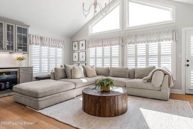 living room with wine cooler, plenty of natural light, and wood finished floors