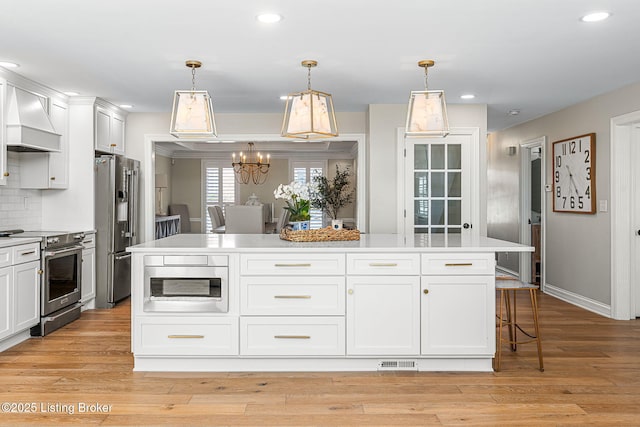 kitchen with premium range hood, stainless steel appliances, visible vents, and light wood finished floors