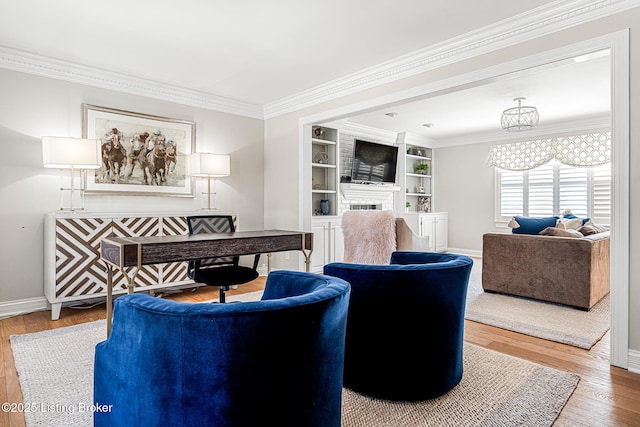 living room featuring wood finished floors, a fireplace, baseboards, and ornamental molding