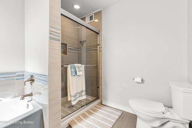 bathroom with a bath, visible vents, a shower stall, and toilet