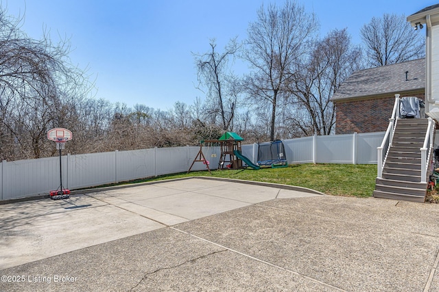 view of patio / terrace with stairway, a playground, and a fenced backyard