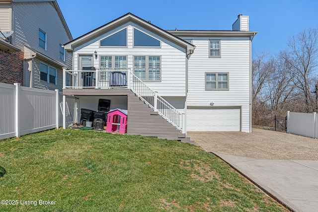 view of front of property featuring driveway, stairs, fence, a front yard, and a chimney