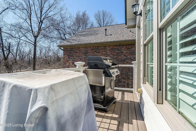 wooden deck with a grill