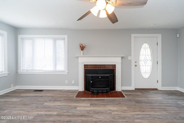 entrance foyer with a ceiling fan, wood finished floors, and baseboards