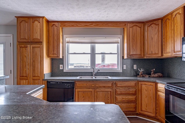 kitchen featuring black appliances, dark countertops, brown cabinets, and a sink