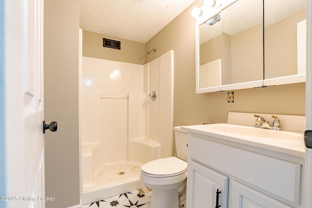 bathroom with vanity, visible vents, a shower, a textured ceiling, and toilet