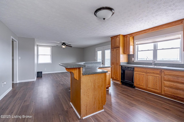 kitchen featuring a sink, dark wood-type flooring, dishwasher, and a breakfast bar