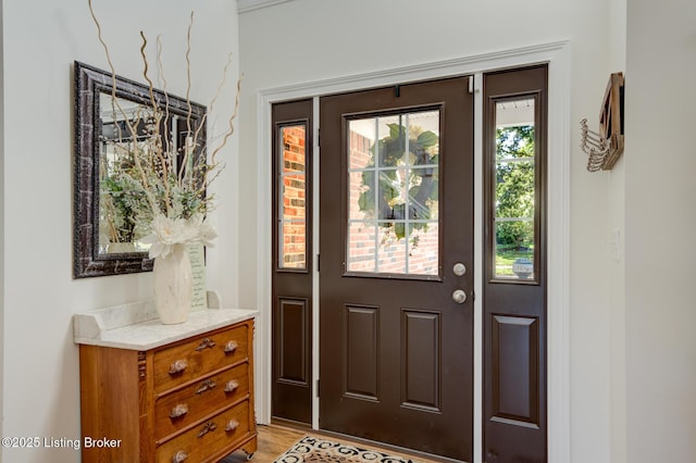 foyer entrance with light wood finished floors