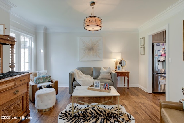 living room with baseboards, wood finished floors, and ornamental molding