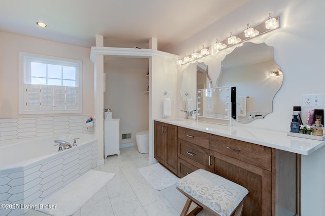 bathroom with visible vents, toilet, a bath, marble finish floor, and vanity