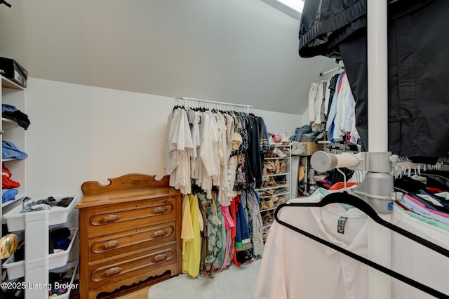 walk in closet featuring lofted ceiling