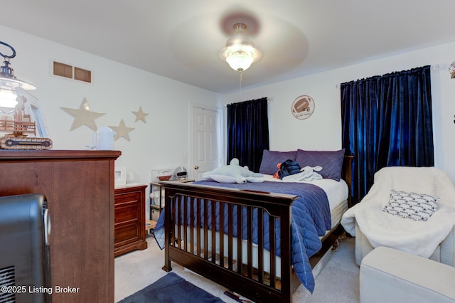 bedroom featuring carpet flooring, a ceiling fan, and visible vents