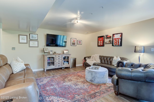 living room featuring wood finished floors and baseboards