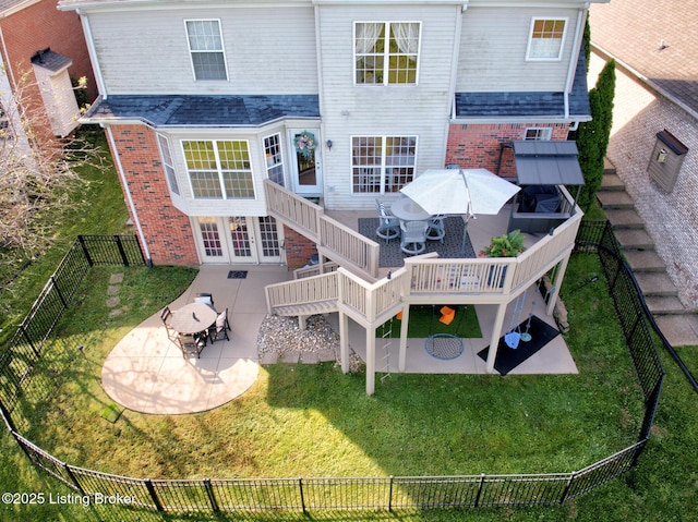 back of house with a patio, a fenced backyard, brick siding, and a lawn