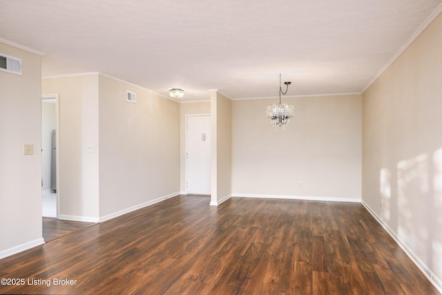 empty room featuring visible vents, baseboards, an inviting chandelier, and dark wood finished floors