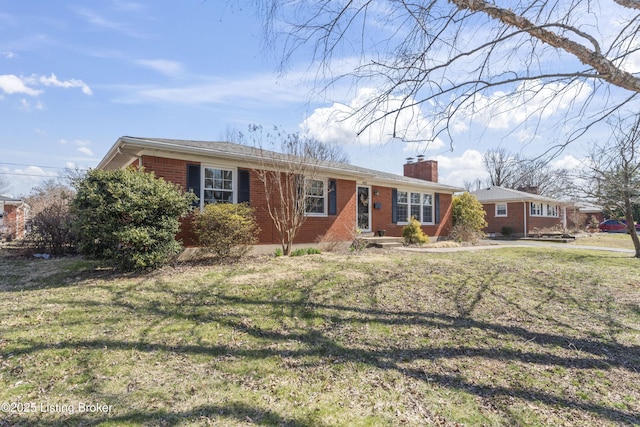 single story home featuring a front yard, brick siding, and a chimney