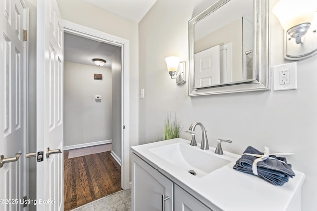 bathroom with vanity and baseboards