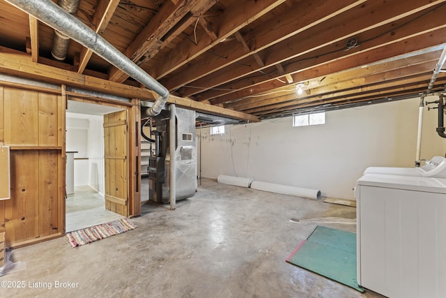 basement featuring heating unit and washer and dryer