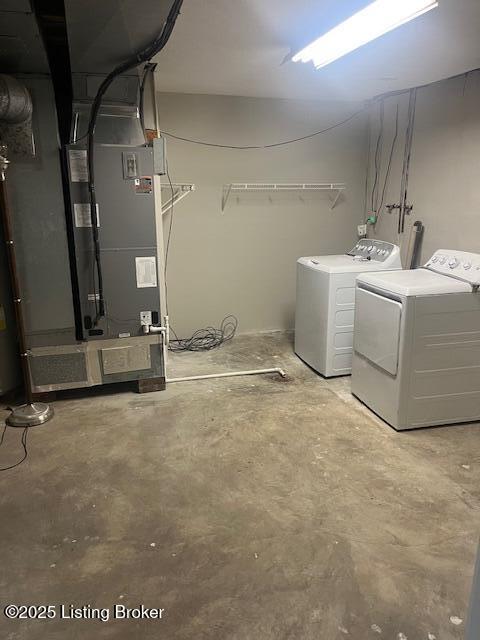 clothes washing area with independent washer and dryer and laundry area