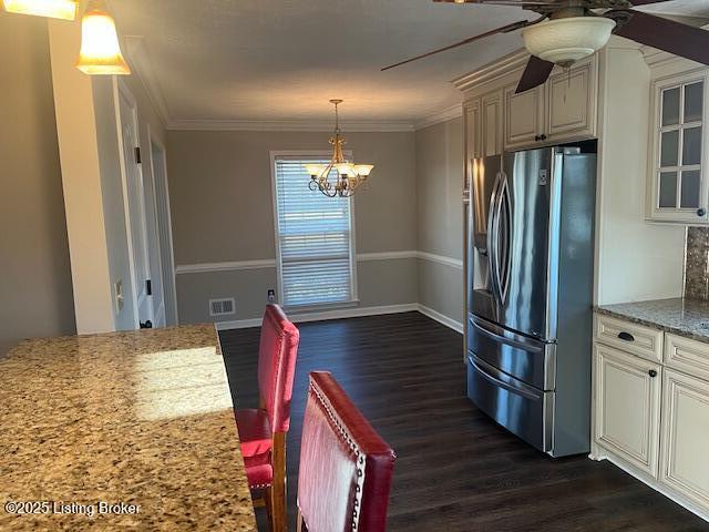 kitchen with dark wood-type flooring, glass insert cabinets, stainless steel refrigerator with ice dispenser, crown molding, and ceiling fan with notable chandelier