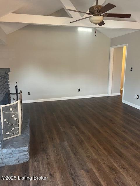 unfurnished living room featuring baseboards, dark wood-type flooring, a ceiling fan, and vaulted ceiling