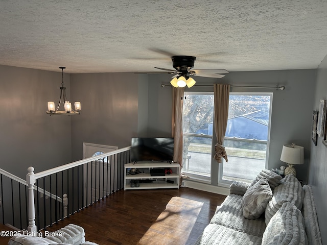 living room featuring a chandelier, a textured ceiling, and wood finished floors