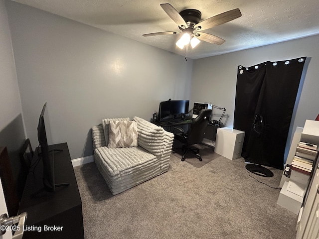 carpeted office space with ceiling fan and a textured ceiling