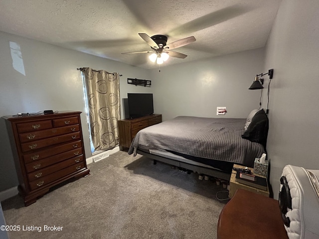 carpeted bedroom with a textured ceiling and ceiling fan