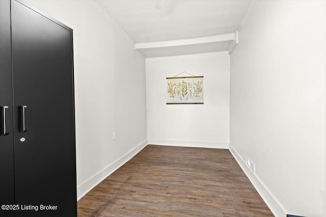 interior space featuring visible vents, baseboards, and dark wood-style flooring