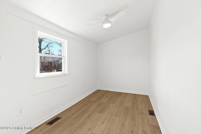 spare room featuring visible vents, baseboards, light wood-style floors, and ceiling fan