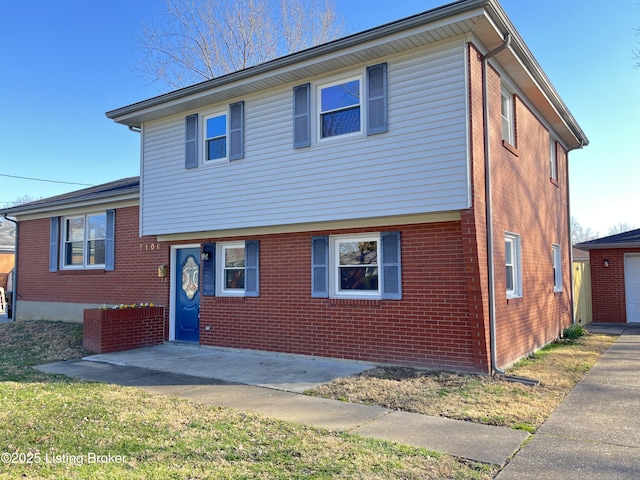 tri-level home with brick siding