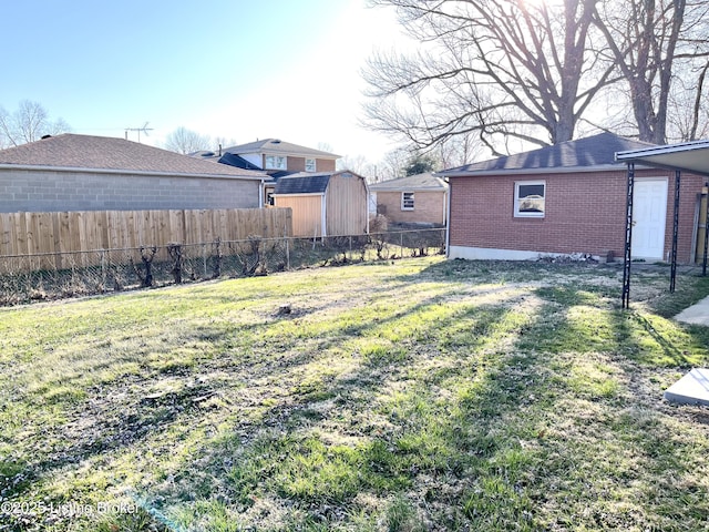 view of yard with an outbuilding and fence