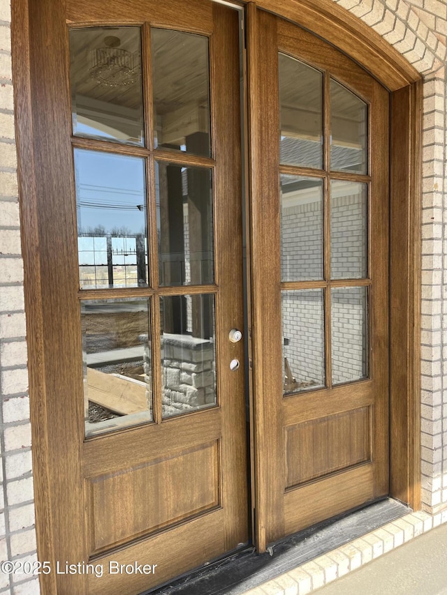 property entrance featuring brick siding