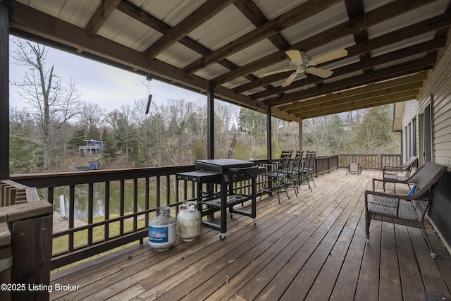 wooden terrace featuring a ceiling fan and grilling area