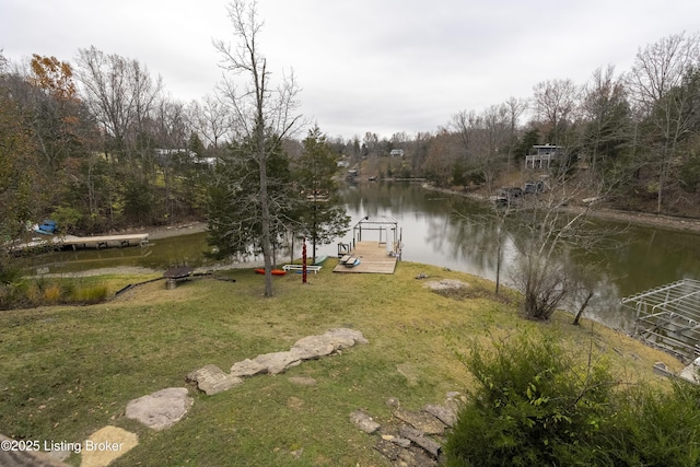 view of yard featuring a boat dock and a water view