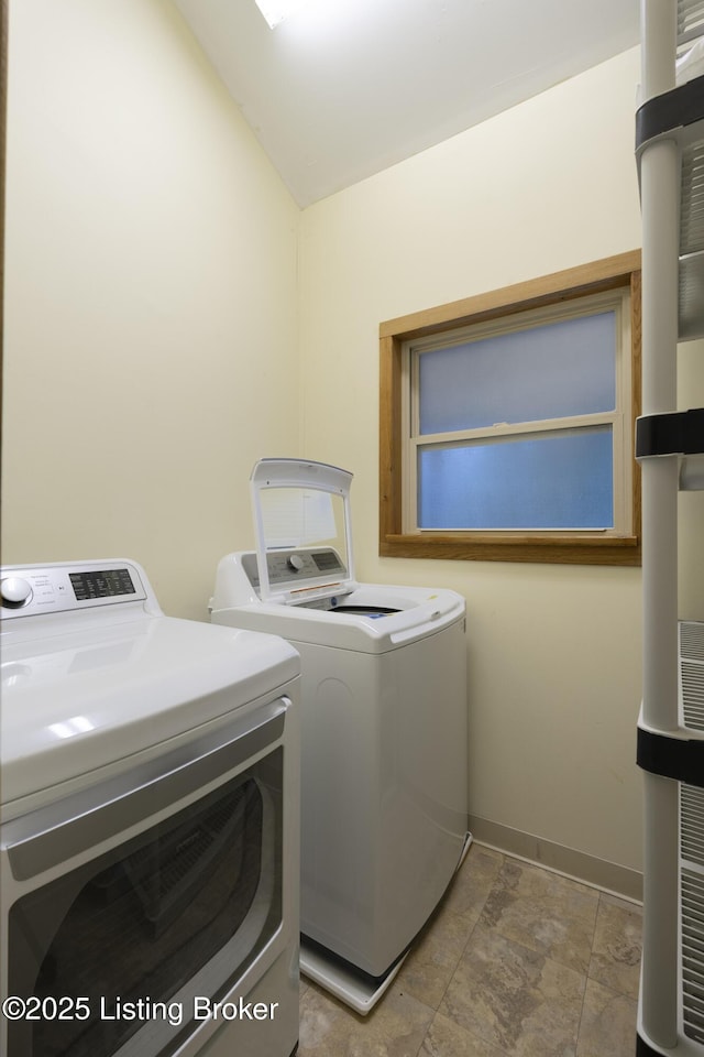 washroom with laundry area, baseboards, and separate washer and dryer