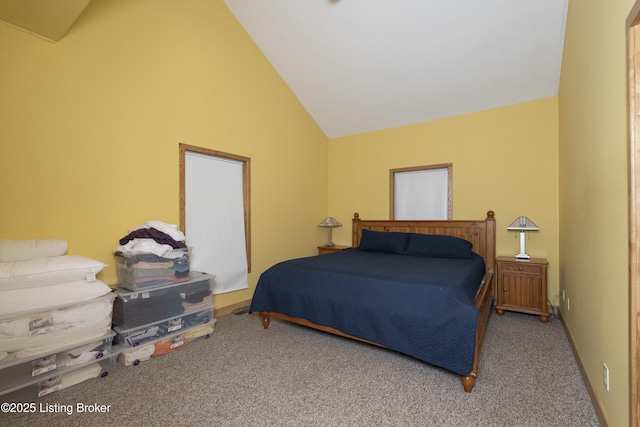 carpeted bedroom with high vaulted ceiling