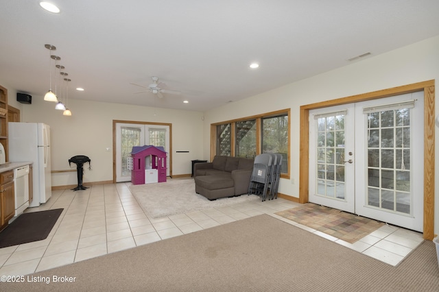 sitting room featuring french doors, light carpet, and visible vents