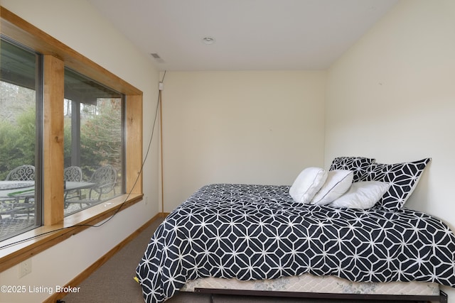 carpeted bedroom featuring baseboards