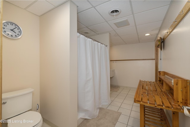 bathroom with a shower with shower curtain, visible vents, toilet, and tile patterned flooring