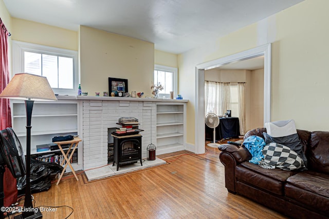 living area featuring hardwood / wood-style flooring and a wood stove