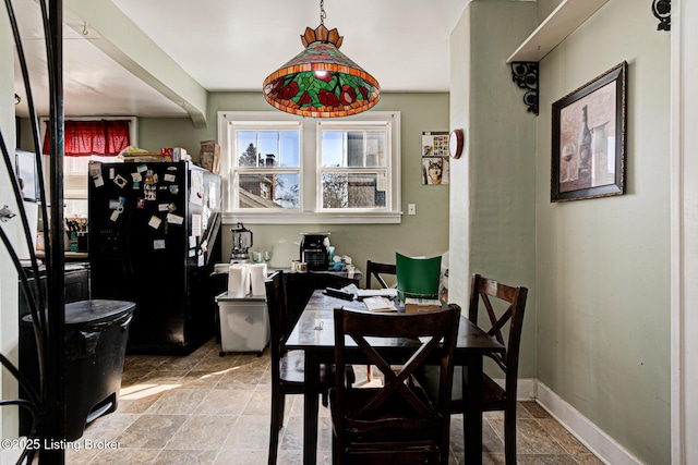 dining area featuring baseboards